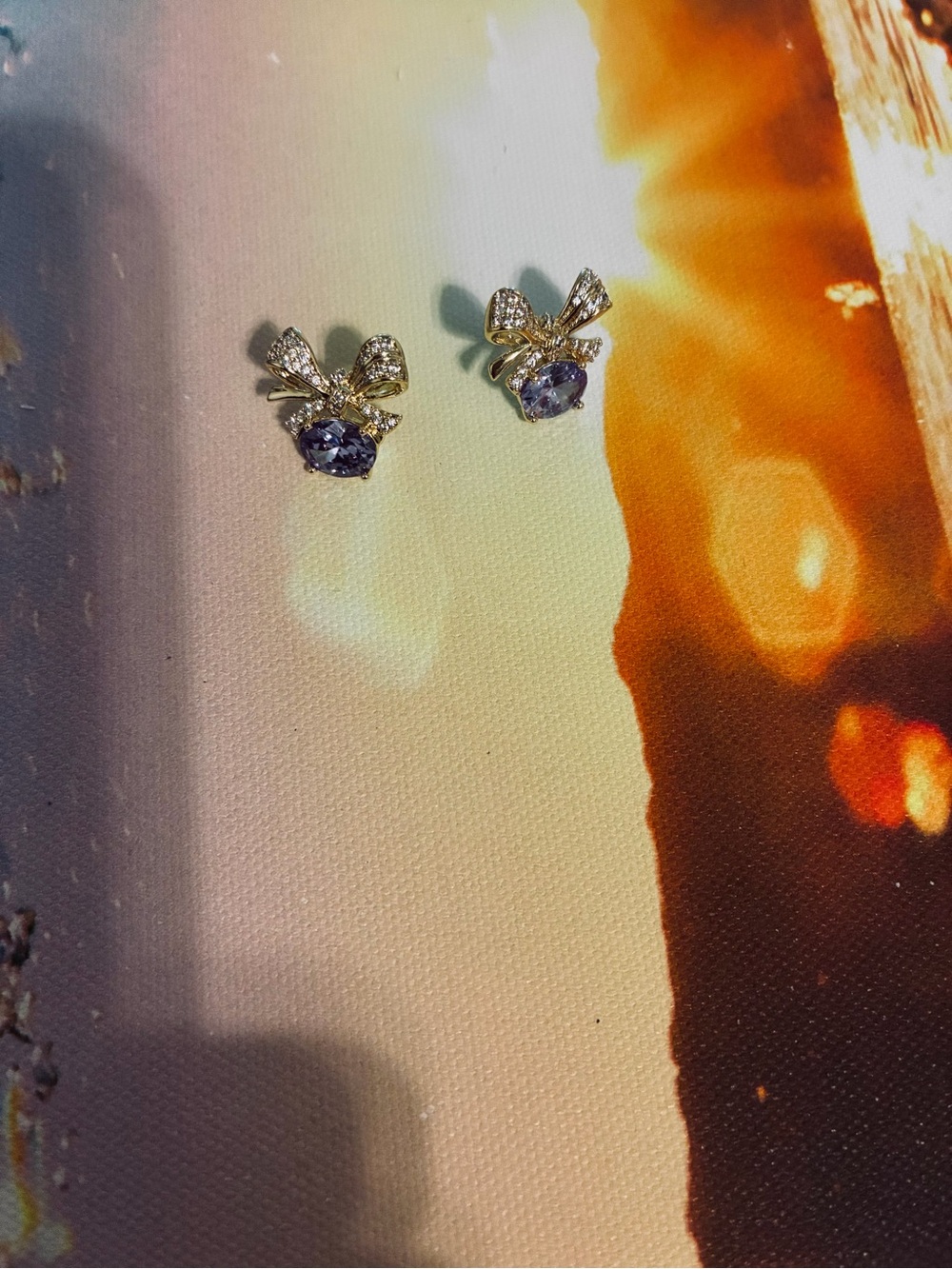 Gold Bow Stud Earrings with Purple Gemstone